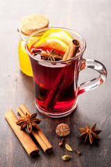 Hot wine with honey and spices in a glass cup