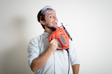 young man bricolage working with electric saw