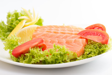Raw salmon fillet with vegetables
