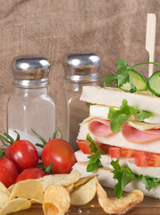 Fresh club sandwich in rustic kitchen setting