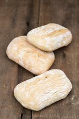 Panini rolls in rustic kitchen setting with cooking utensils
