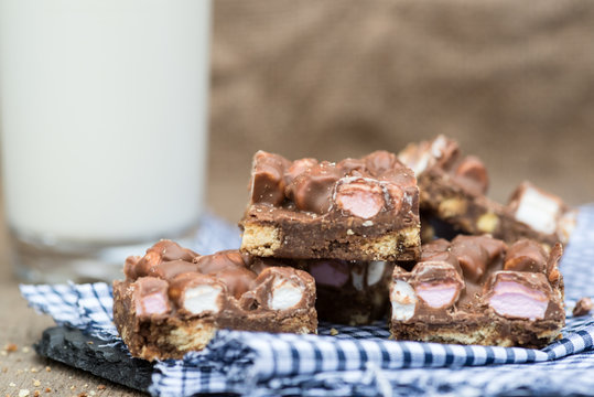 Rustic Background With Rocky Road Dessert Squares With Glass Of