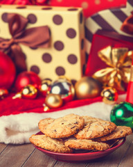 Cookies with christmas gifts on wooden table