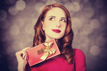 Redhead women with gift.