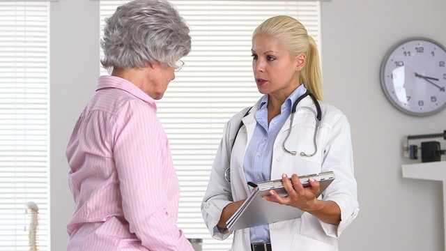 Patient explaining problem to doctor and indicating mouth