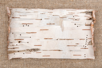 Birch bark on burlap background