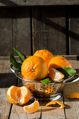 Tangerines in a bowl on a wooden table