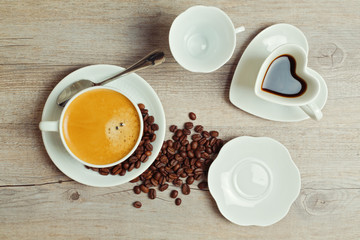 Coffee cups full and empty on wooden table