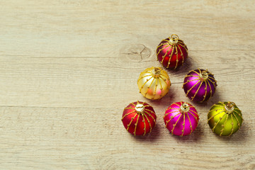 Christmas tree made from decoration balls over wooden background