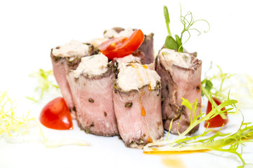 meat rolls with cheese decorated with tomato