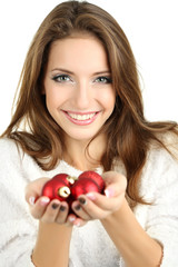 Beautiful smiling girl with Christmas toys isolated on white