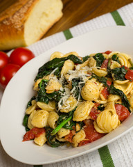 Orecchiette Italian pasta with spinach and tomato meal