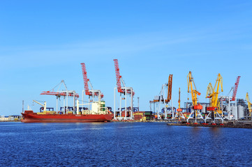 Fototapeta premium Container stack and ship under crane bridge