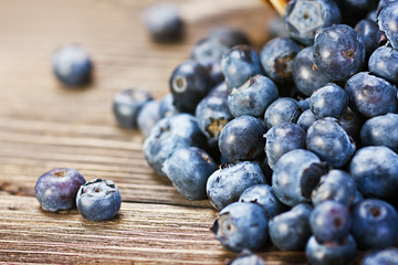 Fresh blueberries scattered on the wooden table