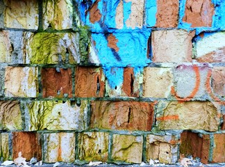 Old brick wall with colorful graffiti