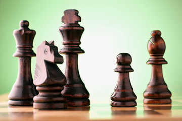 Wooden chess pieces on a chessboard