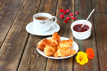 Breakfast with tea homemade croissants and jam