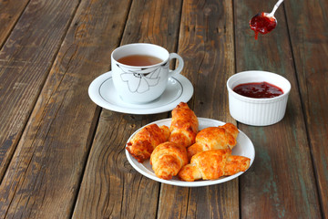 Breakfast with tea homemade croissants and jam