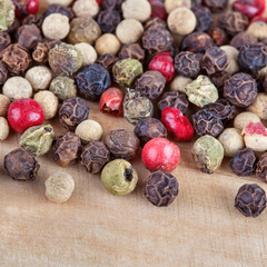 different peppers blend on wooden board