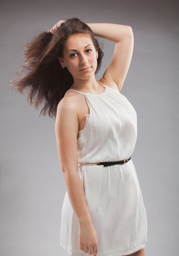 Closeup portrait of sexy brunette girl in white tunic