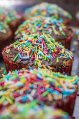 Fototapeta na wymiar Line of cupcakes with sprinkles