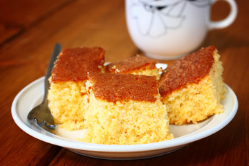 lemon cake and cup of coffee on wooden table