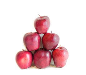 A pyramid of red organic apples isolated on white