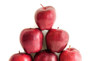 A pyramid of red organic apples isolated on white