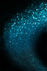 blue abstract glitter trail background made of defocused lights