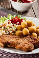 Breaded cutlet and prepared potatoes