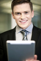 Smiling businessman with tablet pc