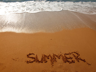 beautiful coastline landscape and handwritten text on the sand