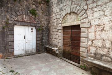 Fototapeta na wymiar Wooden doors on the street of ancient Perast town, Kotor bay, Mo