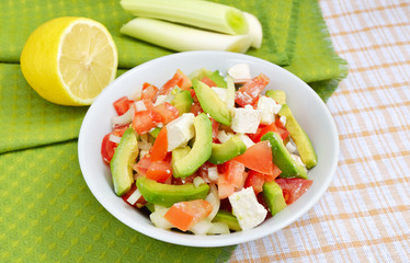 Salad from avocado with feta and tomatoes