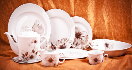 Dinnerware set on orange background