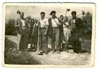 Villagers posing with agricultural machinery - circa 1945 - 58680916