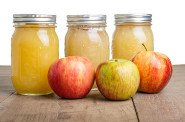 Jars of apple sauce with apples