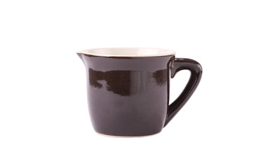A pottery pitcher of milk on white background