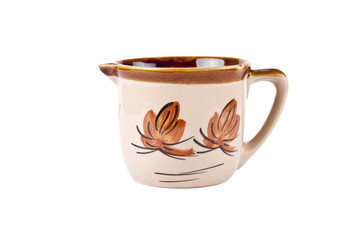 A pottery pitcher of milk on white background