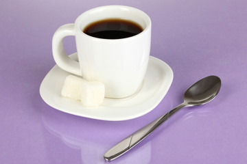 A cup of strong coffee on purple background