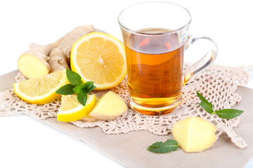 Cup of tea with ginger on napkin isolated on white