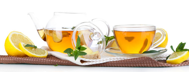 Kettle and cup of tea with ginger on napkin isolated on white
