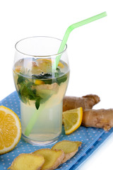 Glass of cold tea with ginger on napkin isolated on white