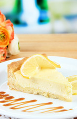 Slice of  lemon cheesecake  and sauce