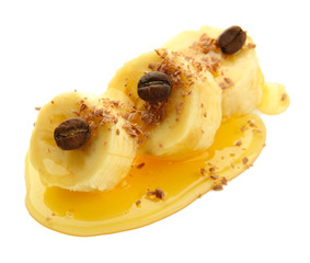 Banana slices with honey, isolated on white