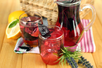 Red basil lemonade in jug and glass,