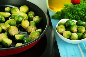Fresh brussels sprouts in pan on cooking surface close-up