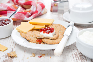 delicious breakfast with crackers, cream cheese and berry jam