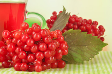 Red berries of viburnum and cup of tea