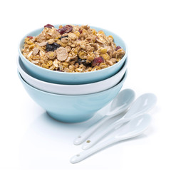 homemade granola in a bowl and spoons, isolated